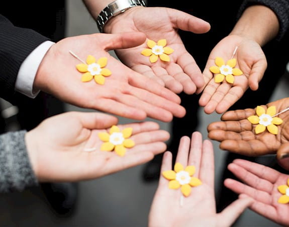 People showing the daffodil pins in their palms