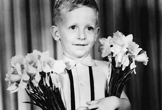 A child holding daffodils